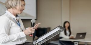 Lecturer speaking into a microphone