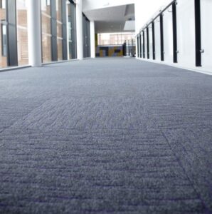 Array carpet tiles in purple in a school corridor 