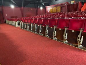 Claret in the aisle directly Infront of the stage, showing the first set of seats